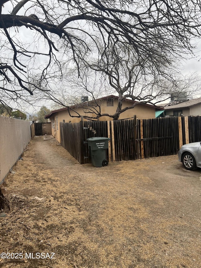 view of side of home with fence