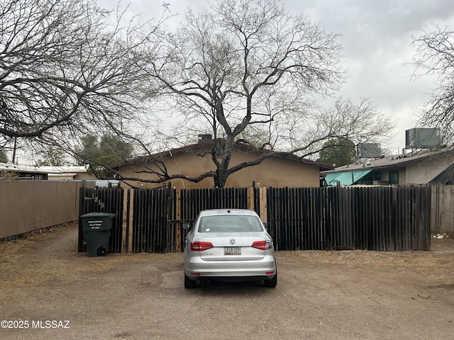 view of parking / parking lot with fence