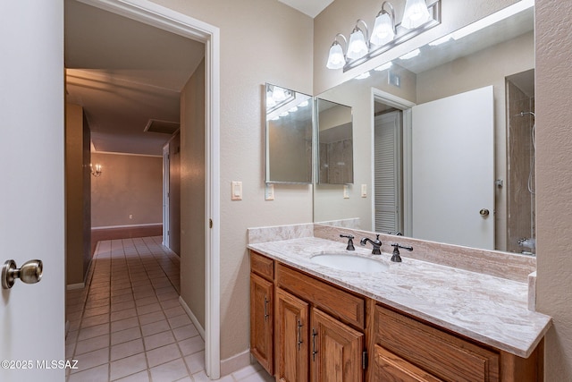 full bathroom featuring vanity, tile patterned floors, and baseboards