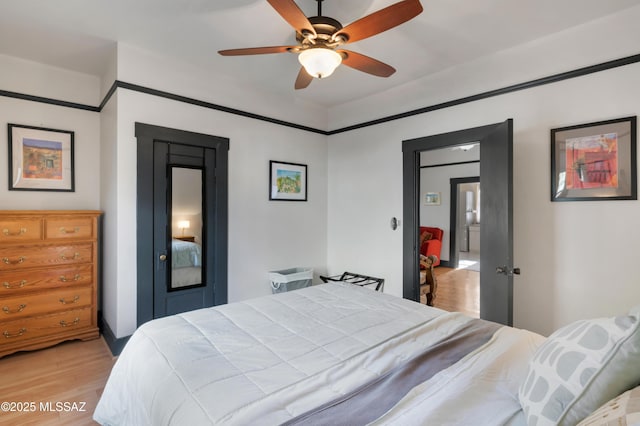 bedroom featuring light wood-type flooring and a ceiling fan