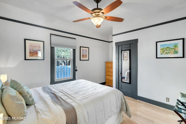 bedroom with baseboards, light wood-style floors, and ceiling fan