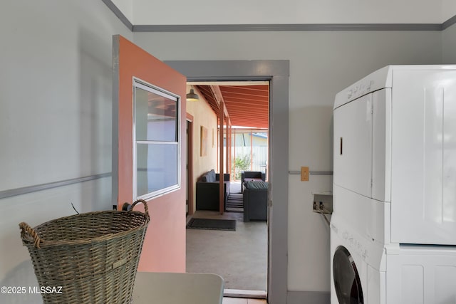 washroom with laundry area and stacked washer / dryer