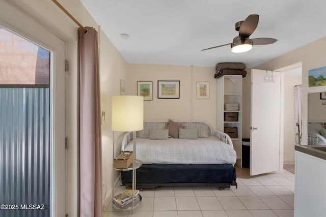 bedroom featuring light tile patterned floors and ceiling fan