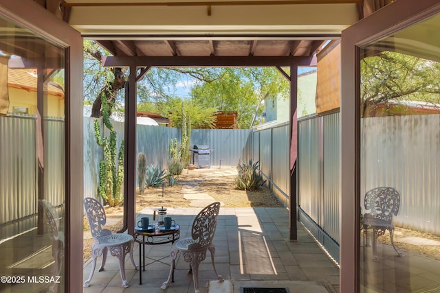 view of patio with outdoor dining area and a fenced backyard