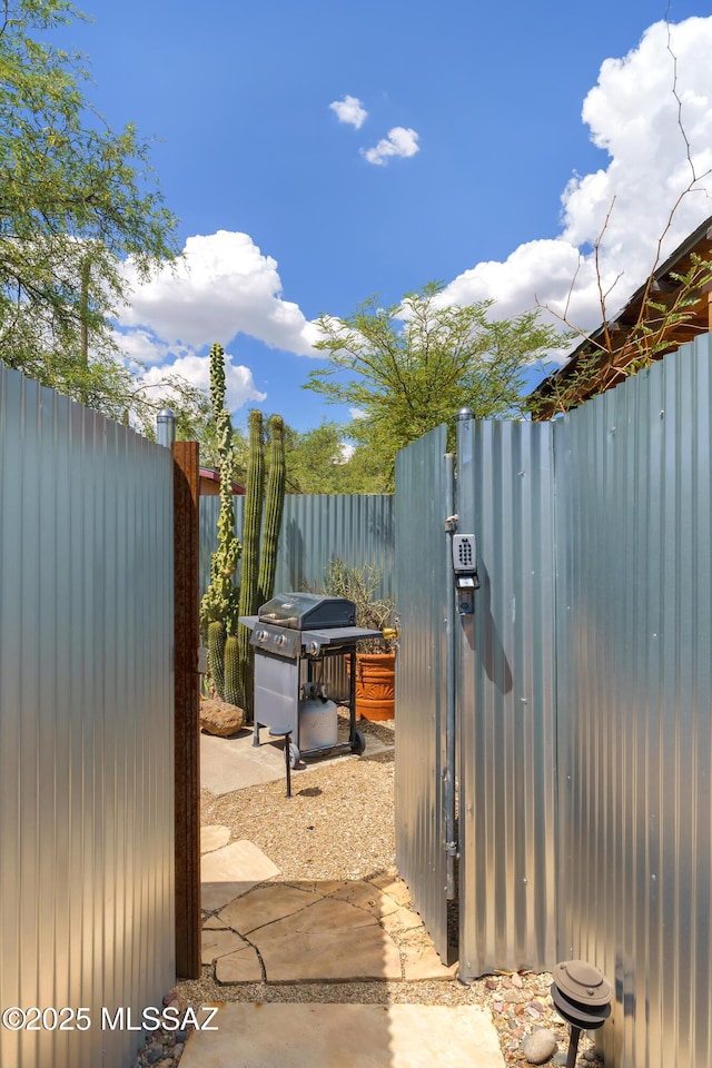 view of patio / terrace with a grill and fence