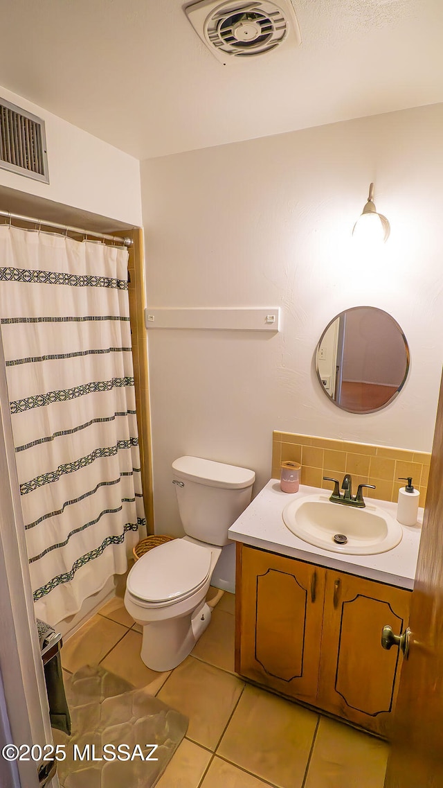 bathroom featuring tile patterned flooring, vanity, visible vents, and toilet