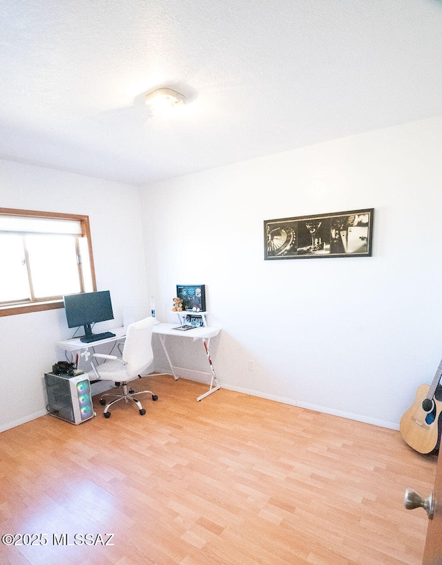 office space with baseboards and wood finished floors
