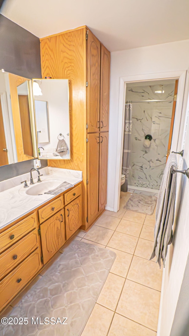 bathroom with tile patterned floors, vanity, a shower with curtain, and toilet