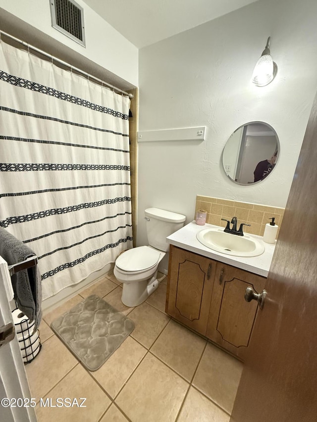 bathroom featuring vanity, visible vents, decorative backsplash, tile patterned floors, and toilet