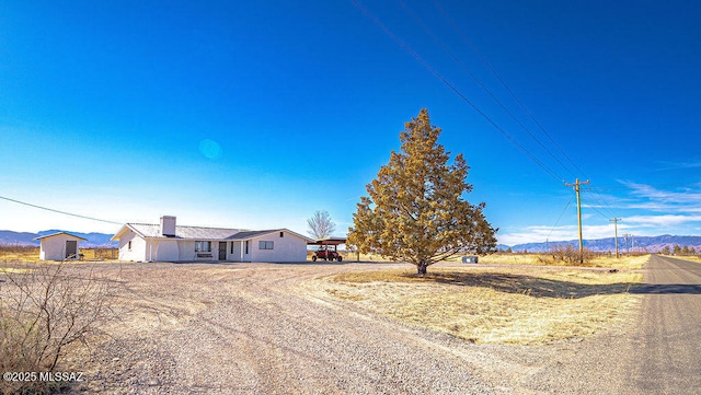 view of front of property with a mountain view and a chimney