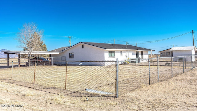 back of property with a fenced backyard and an outdoor structure