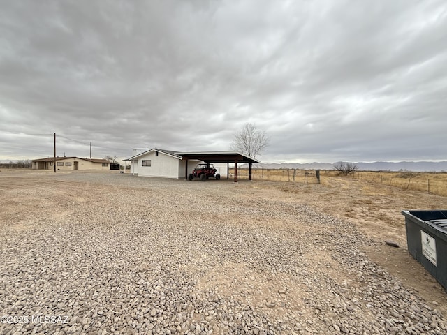 view of yard featuring a rural view and an outdoor structure