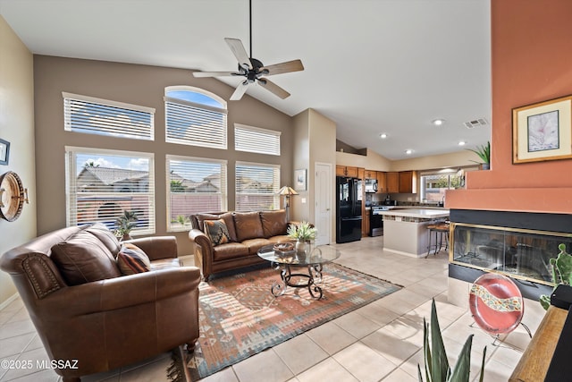 living area featuring visible vents, recessed lighting, light tile patterned flooring, high vaulted ceiling, and a ceiling fan