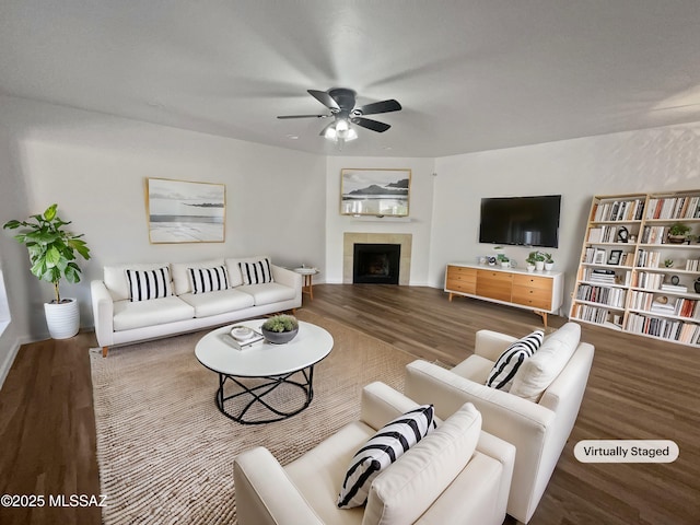 living room with wood finished floors, a fireplace, and ceiling fan