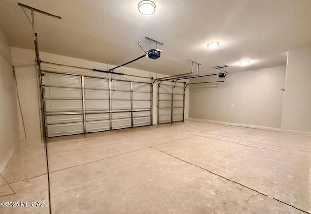 garage featuring a garage door opener and baseboards