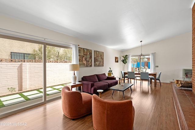 living room featuring wood finished floors and lofted ceiling
