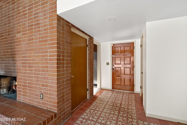 hall with baseboards and tile patterned flooring