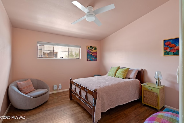 bedroom featuring baseboards, a ceiling fan, vaulted ceiling, and wood finished floors