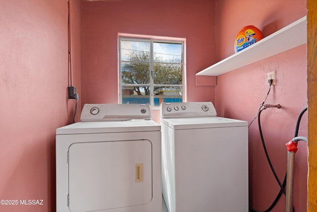 clothes washing area with separate washer and dryer and laundry area