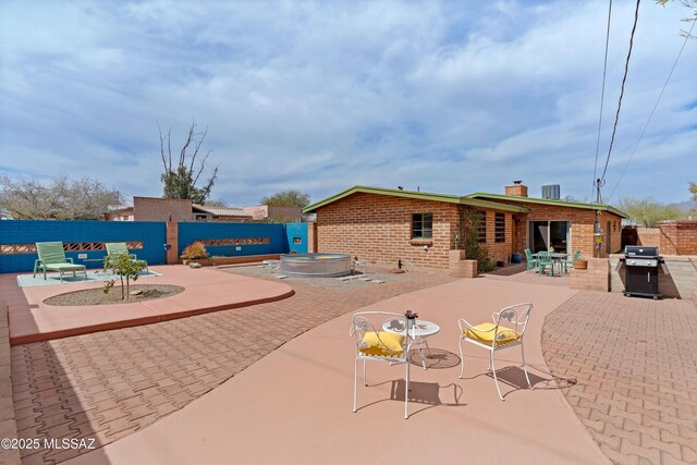 exterior space with outdoor dining space and fence