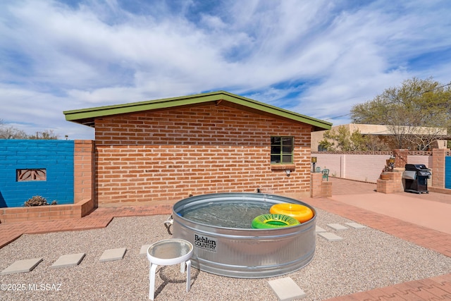 view of patio with grilling area and fence