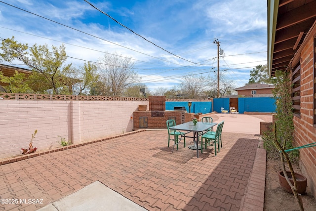 view of patio featuring a fenced backyard and outdoor dining area