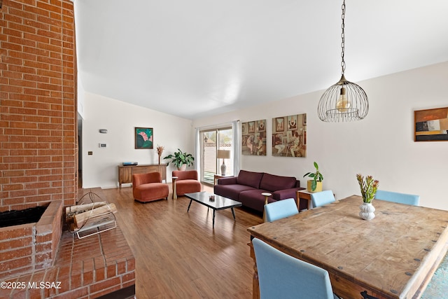 dining area featuring wood finished floors and lofted ceiling