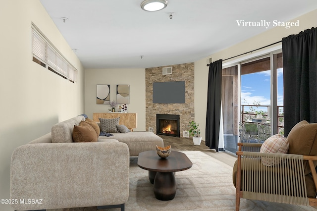 living room with a fireplace and visible vents