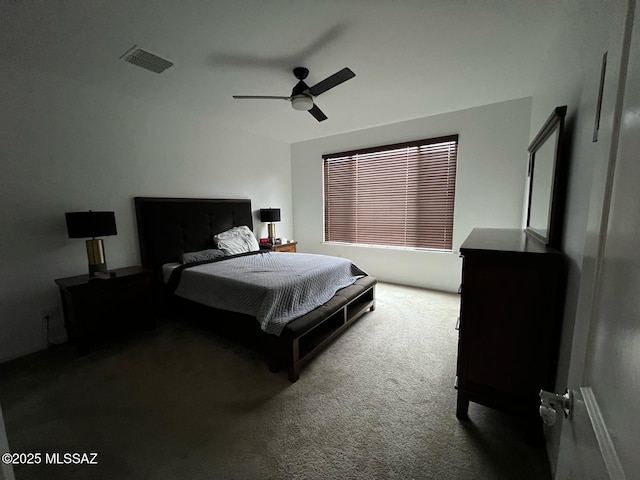 carpeted bedroom with lofted ceiling, a ceiling fan, and visible vents