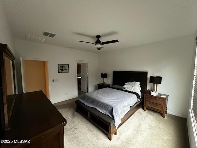 bedroom with light carpet, visible vents, and a ceiling fan