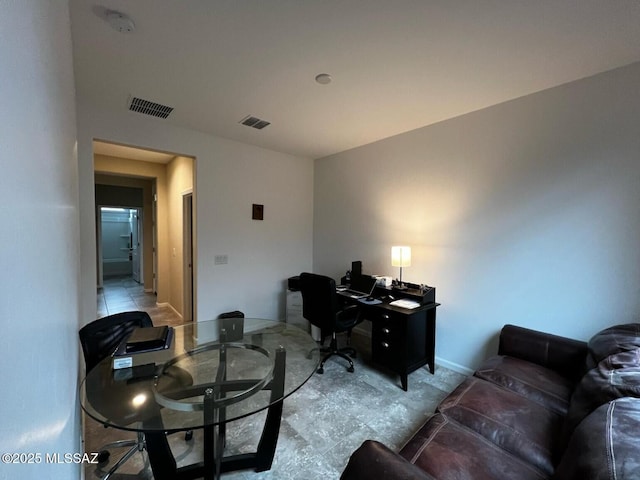 office space featuring baseboards and visible vents