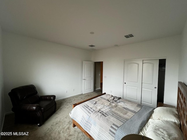 bedroom featuring a closet, baseboards, visible vents, and carpet floors