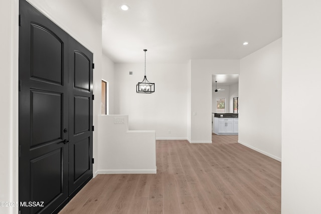 entryway with recessed lighting, baseboards, and light wood-style floors