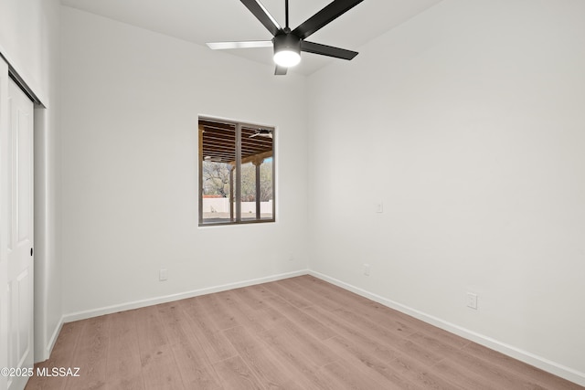 unfurnished bedroom with ceiling fan, baseboards, a closet, and light wood-type flooring