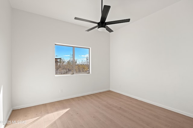 spare room featuring ceiling fan, baseboards, and wood finished floors