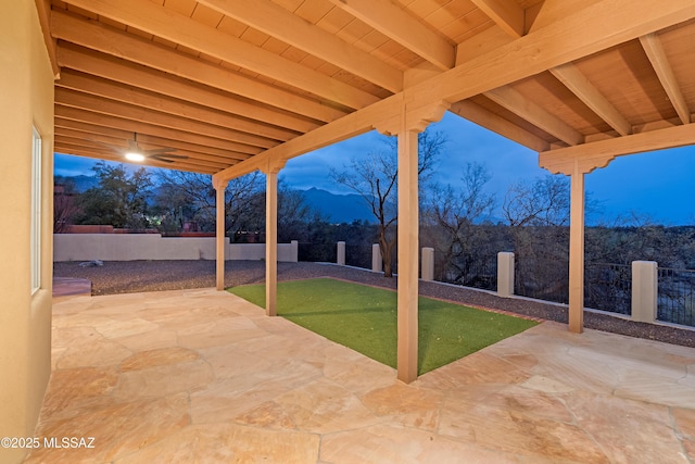 view of patio / terrace with a mountain view and a fenced backyard