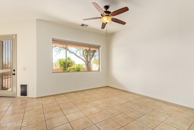 empty room with light tile patterned floors, visible vents, and ceiling fan