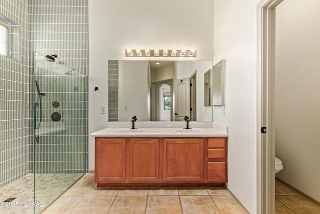 bathroom featuring double vanity, a walk in shower, and a sink