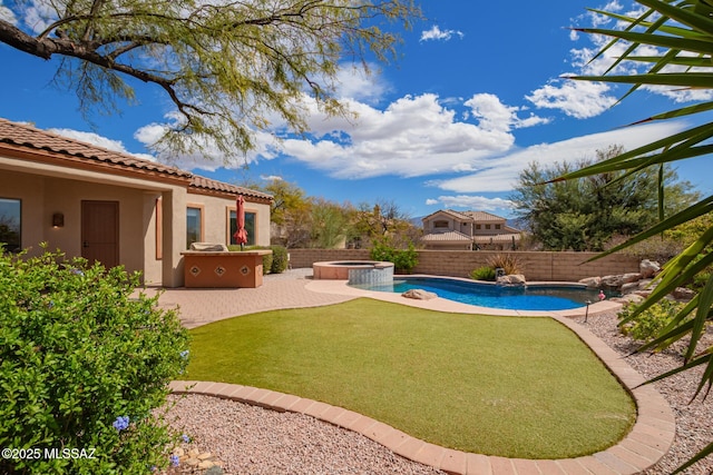 view of yard featuring a patio area, a fenced backyard, and a pool with connected hot tub