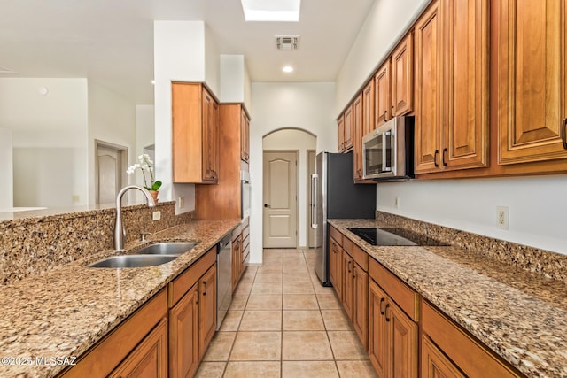 kitchen featuring a sink, visible vents, brown cabinets, and appliances with stainless steel finishes