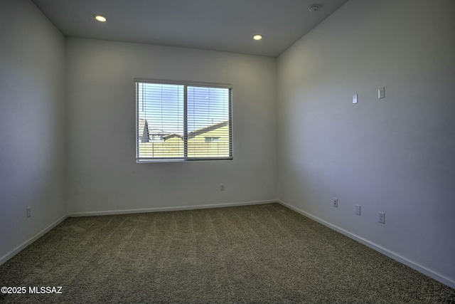 spare room with recessed lighting, baseboards, and carpet