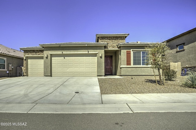 view of front facade with stone siding, stucco siding, driveway, and a garage