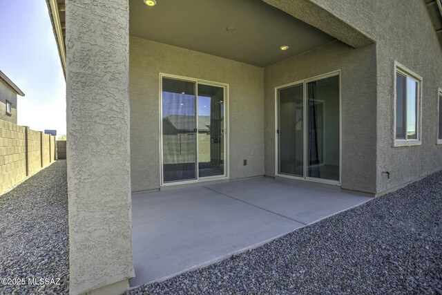 view of patio featuring fence