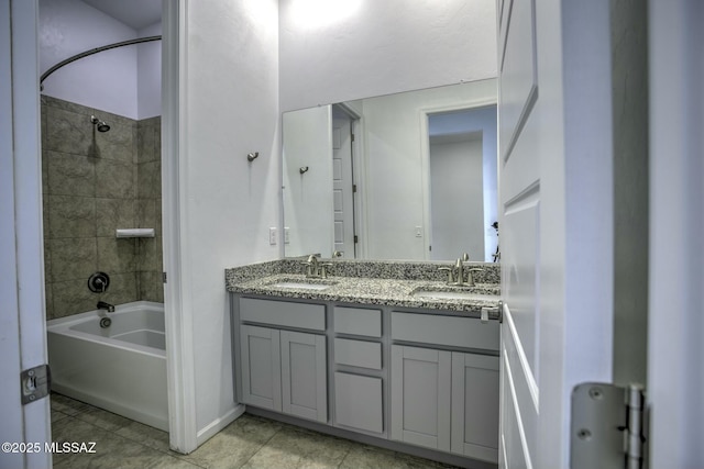 full bath featuring tile patterned flooring, double vanity, shower / bathtub combination, and a sink