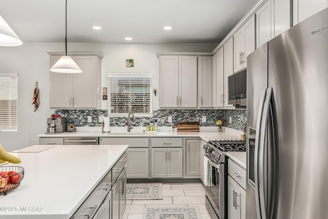 8707 N Ash Grove Ct, Tucson, AZ 85742 - kitchen with appliances with stainless steel finishes, decorative backsplash, light countertops, recessed lighting, and gray cabinetry
