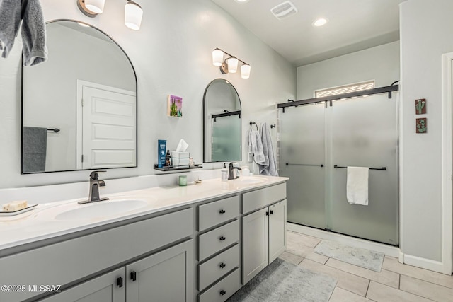 8707 N Ash Grove Ct, Tucson, AZ 85742 - bathroom with double vanity, a shower stall, tile patterned flooring, and recessed lighting