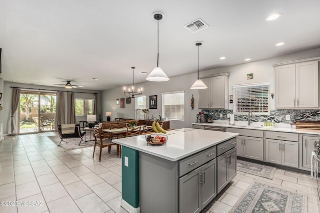 8707 N Ash Grove Ct, Tucson, AZ 85742 - kitchen featuring gray cabinets, open floor plan, light countertops, decorative backsplash, and a kitchen island