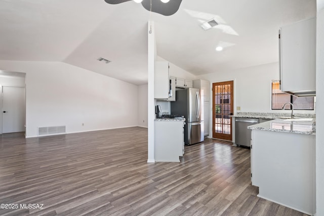 kitchen featuring open floor plan, appliances with stainless steel finishes, and visible vents