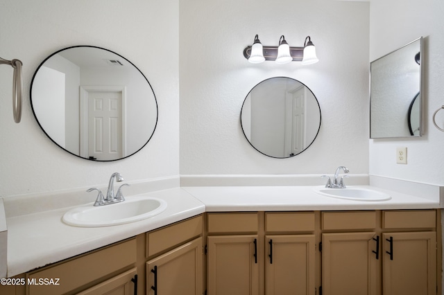 full bathroom with double vanity and a sink