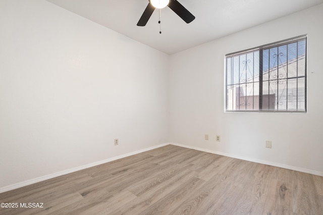 spare room with light wood finished floors and baseboards